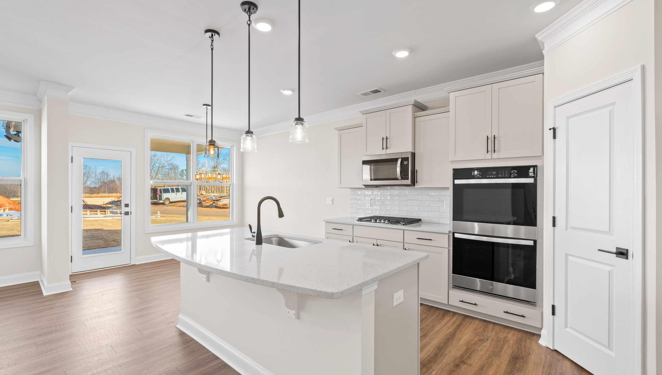 Kitchen and island with granite counter tops.