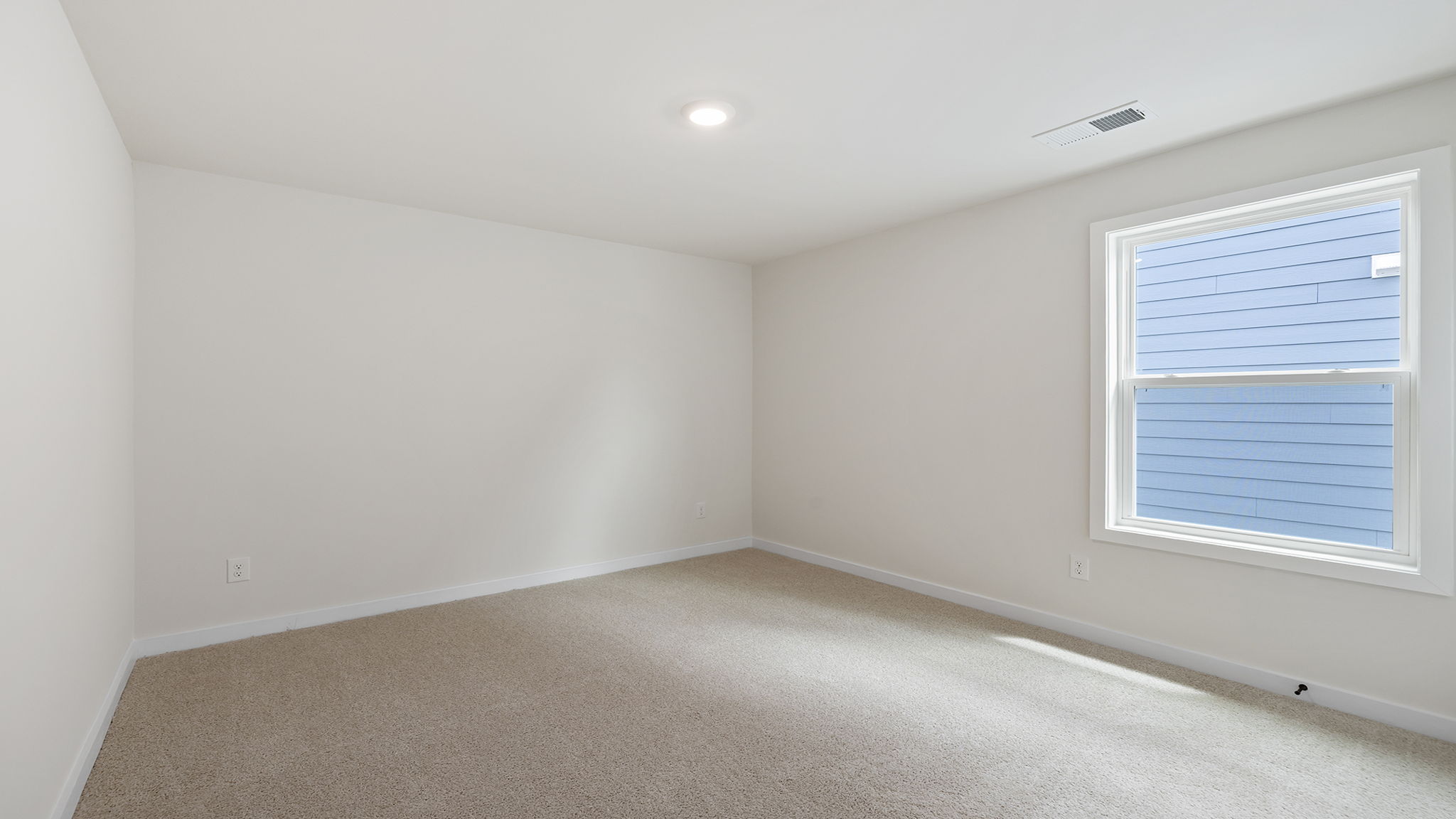 Bedroom with carpet and window.