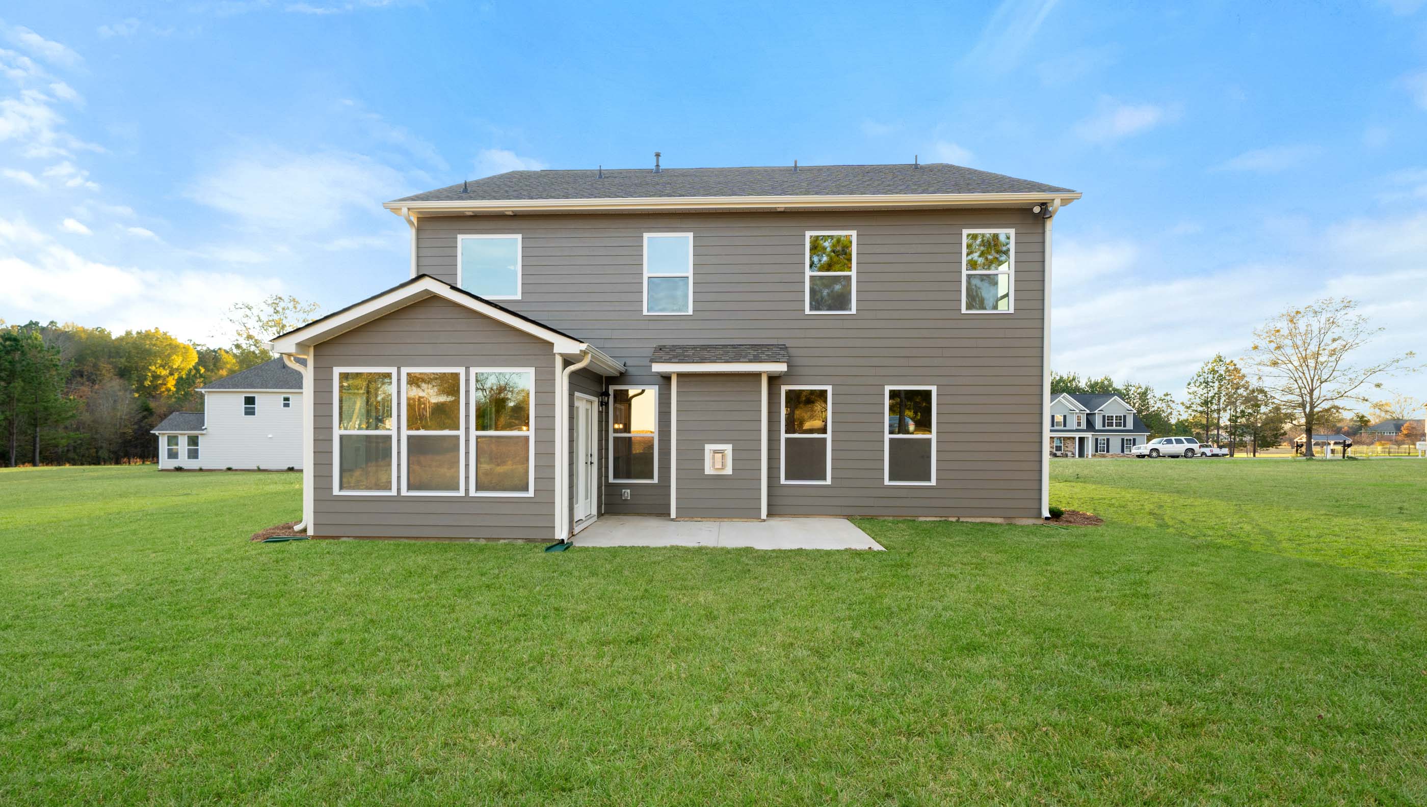 Back exterior of home with large backyard.