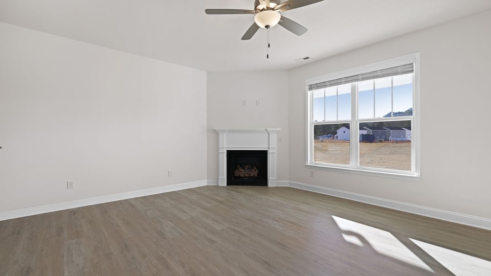 Family room with fireplace and windows.