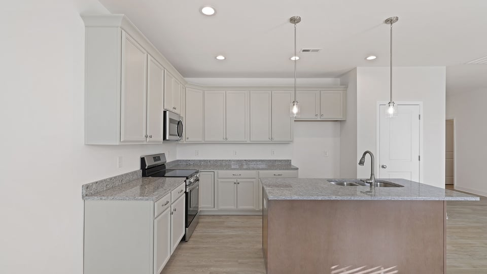 Kitchen with island and granite countertops.
