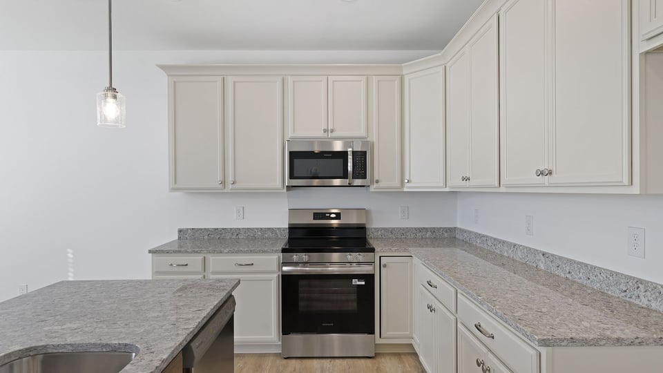 Kitchen with island and granite countertops.