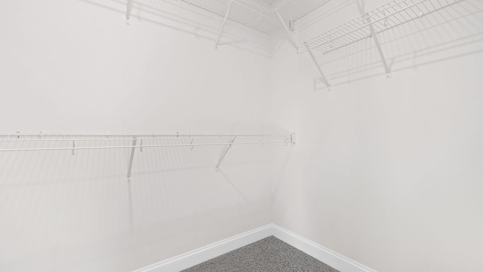 Walk in closet with shelves.