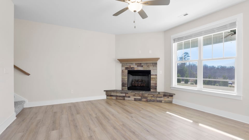 Family room with fireplace and windows.