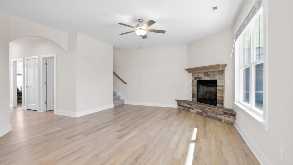 Family room with fireplace and windows.