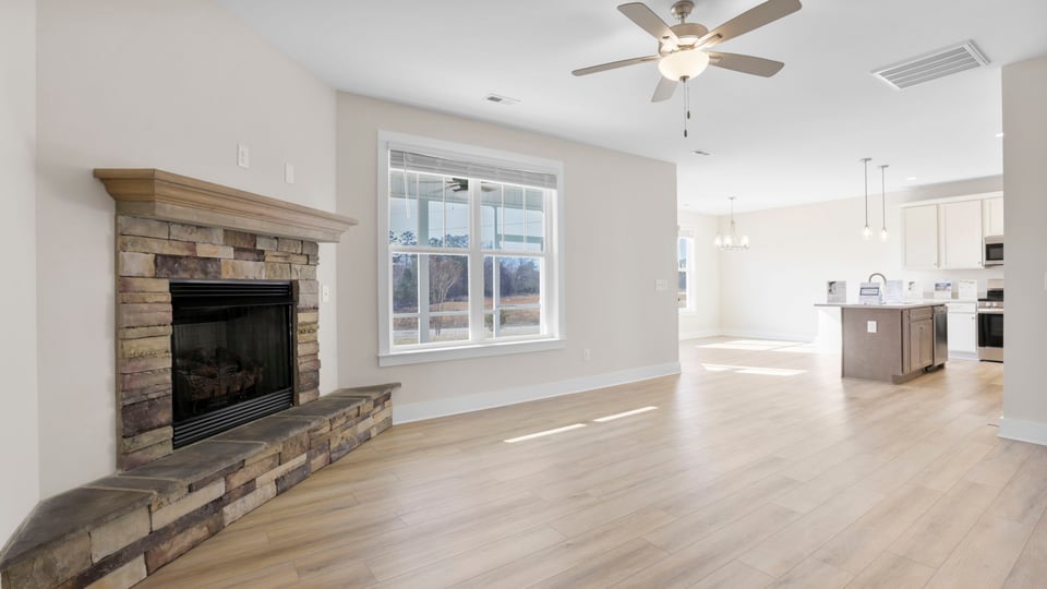 Family room with fireplace and windows.