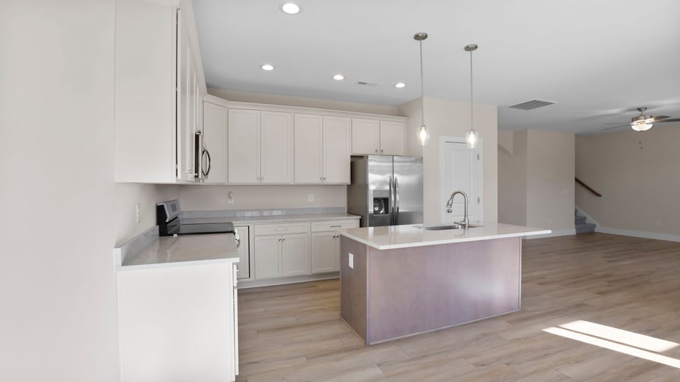 Kitchen with island and quartz countertops.