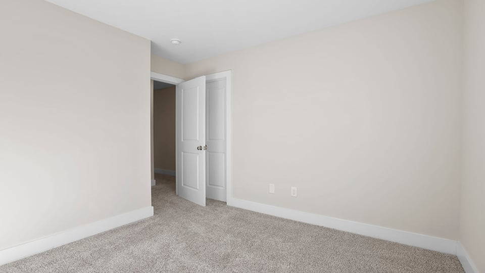 Bedroom with carpet and window.