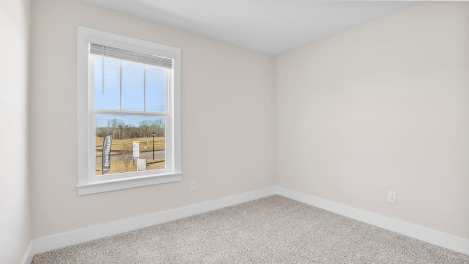Bedroom with carpet and window.