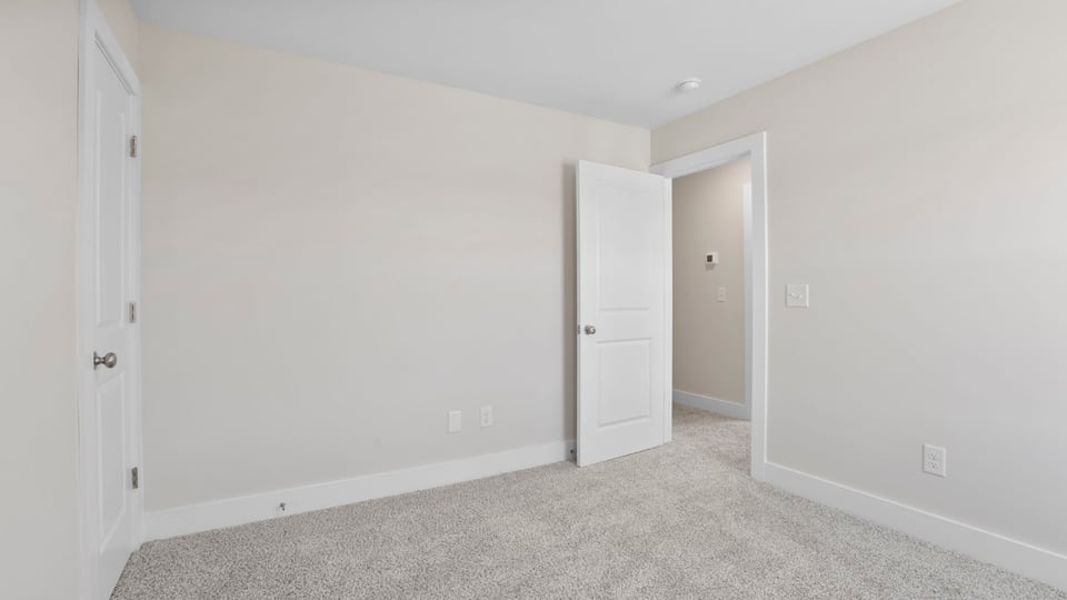 Bedroom with carpet and window.