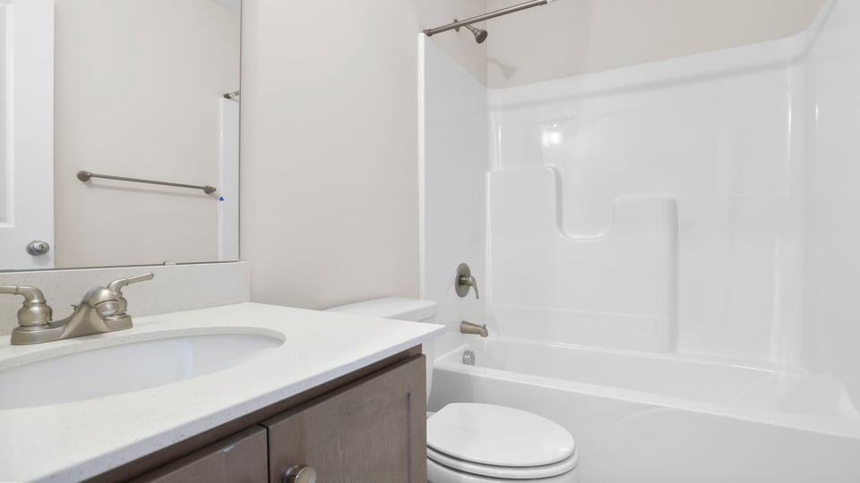 Bathroom with single vanity sink and tub.