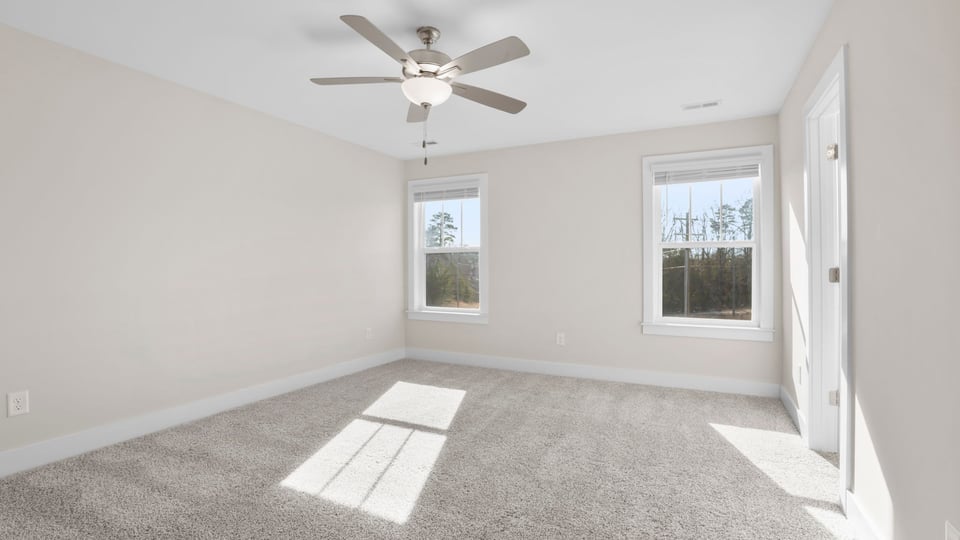Bedroom with carpet and window.