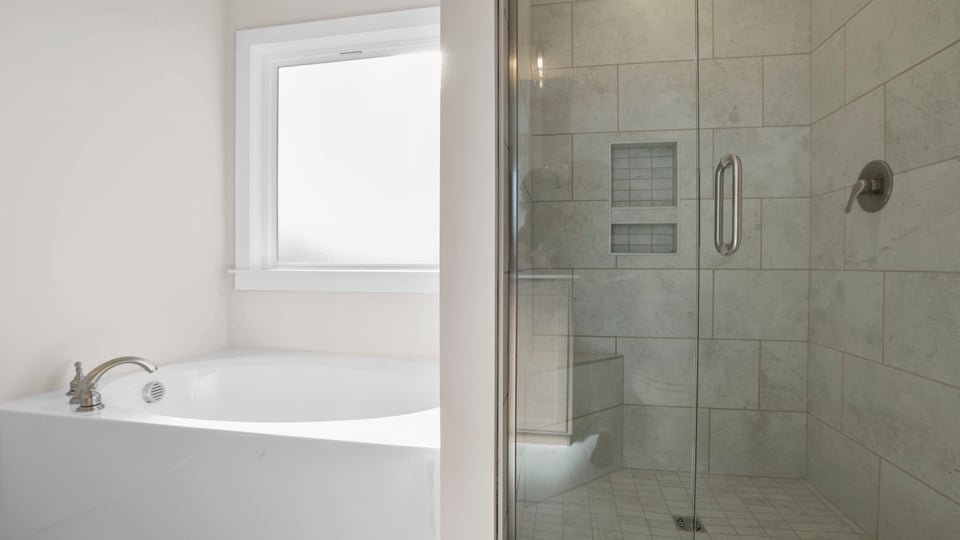 Bathroom with tub and walk in shower.