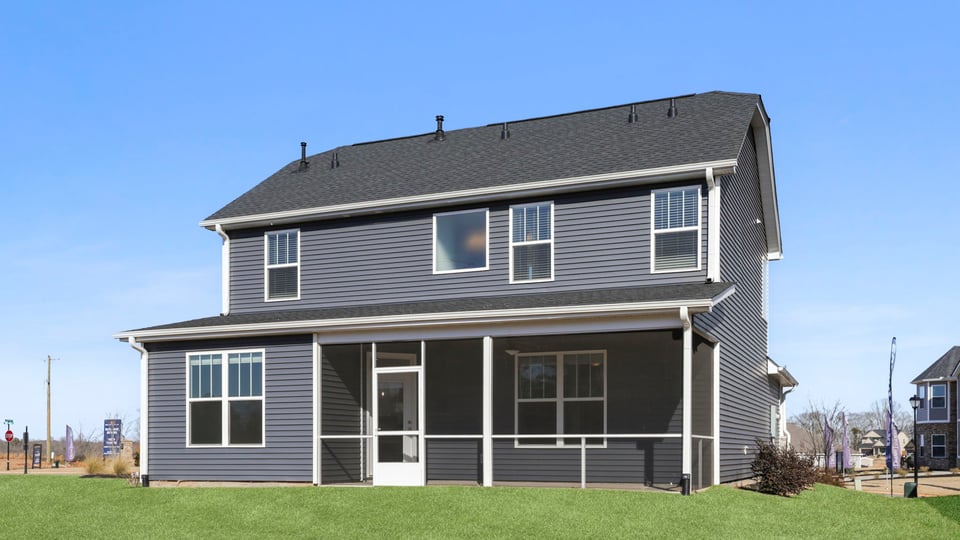 Back exterior of home with large backyard.