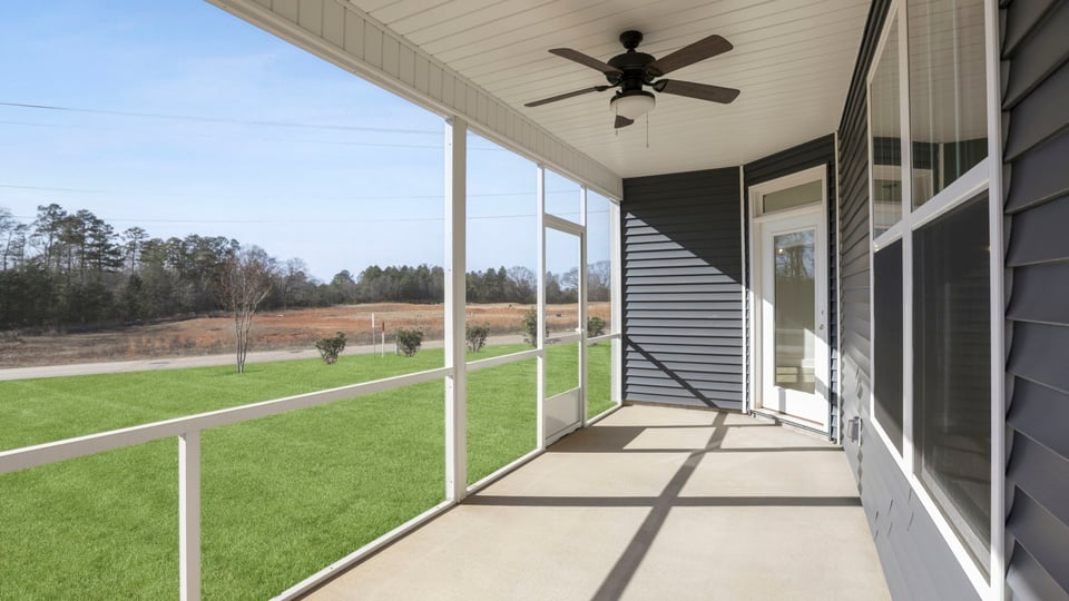 Back exterior of home with covered patio.