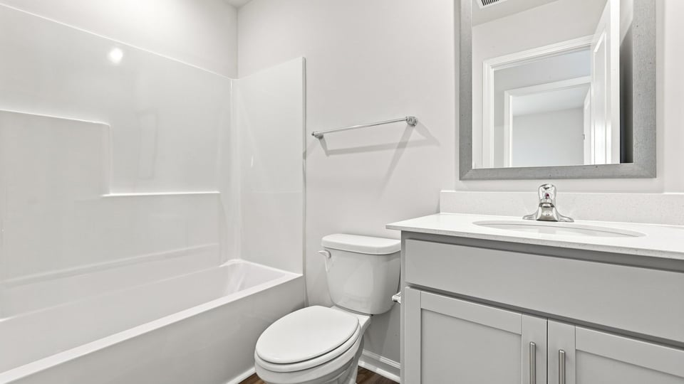 Bathroom with single vanity sink and bathtub.