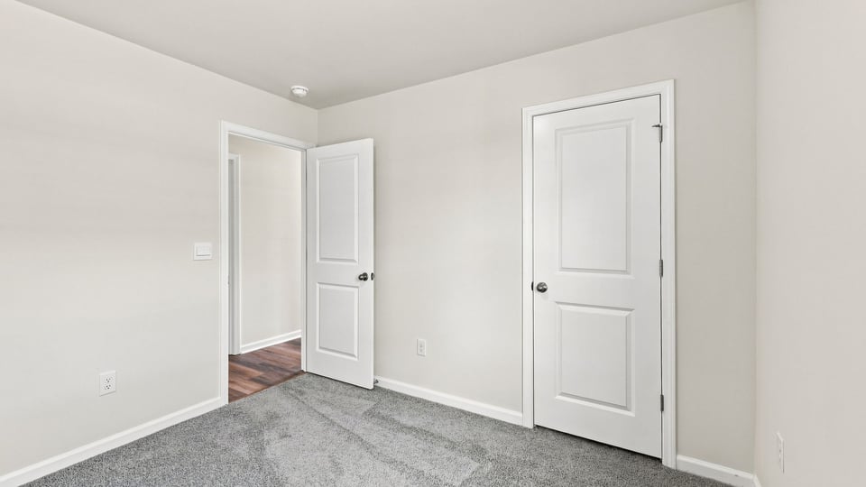 Bedroom with carpet and window.