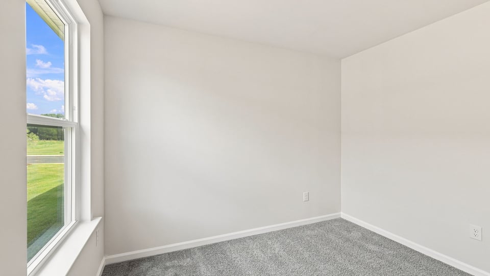 Bedroom with carpet and window.