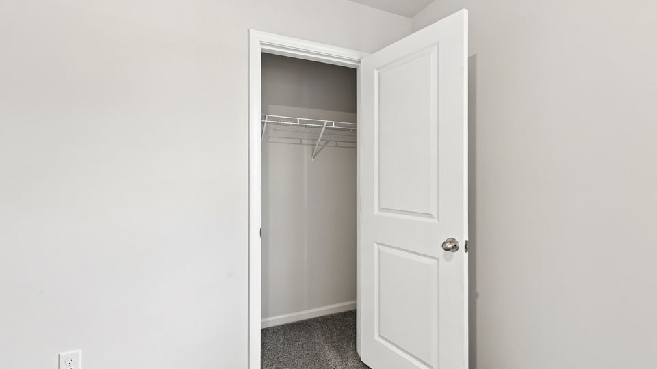 Bedroom with carpet and window.