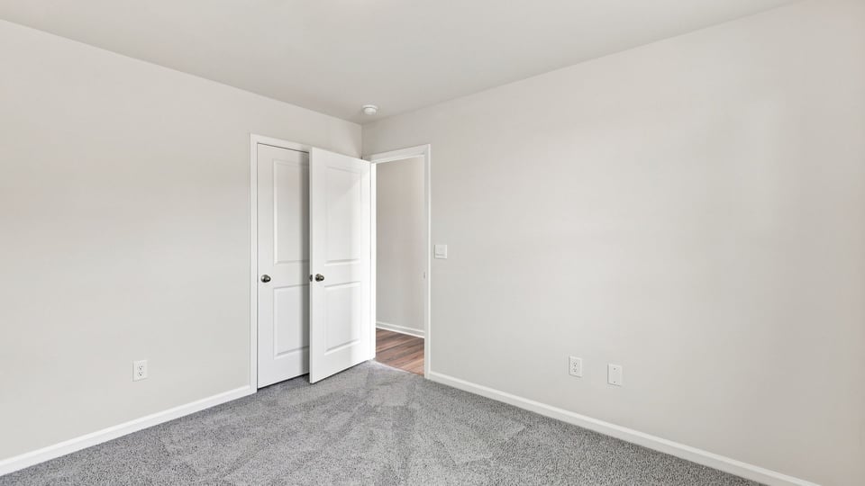 Bedroom with carpet and window.