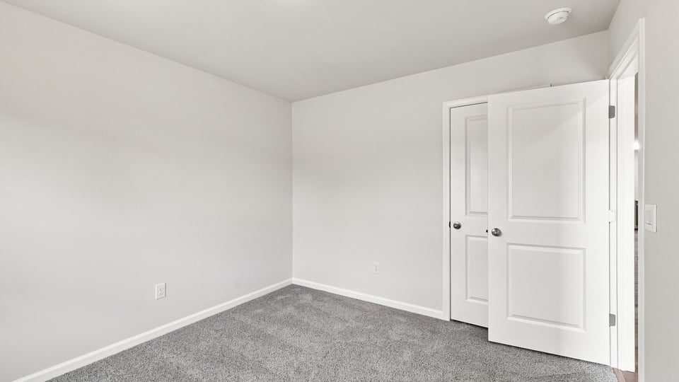 Bedroom with carpet and window.
