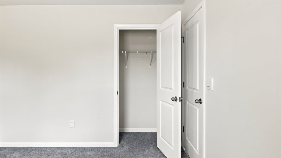 Bedroom with carpet and window.