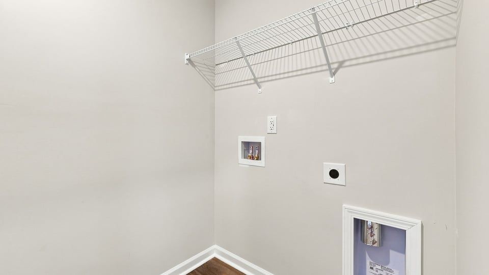 Laundry room with hanging storage racks.