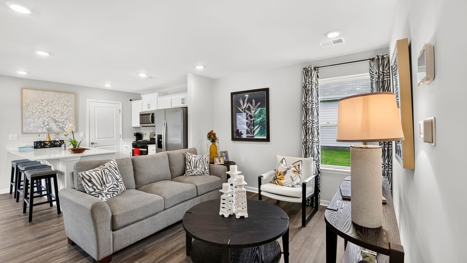 Livingroom of home with view of kitchen.