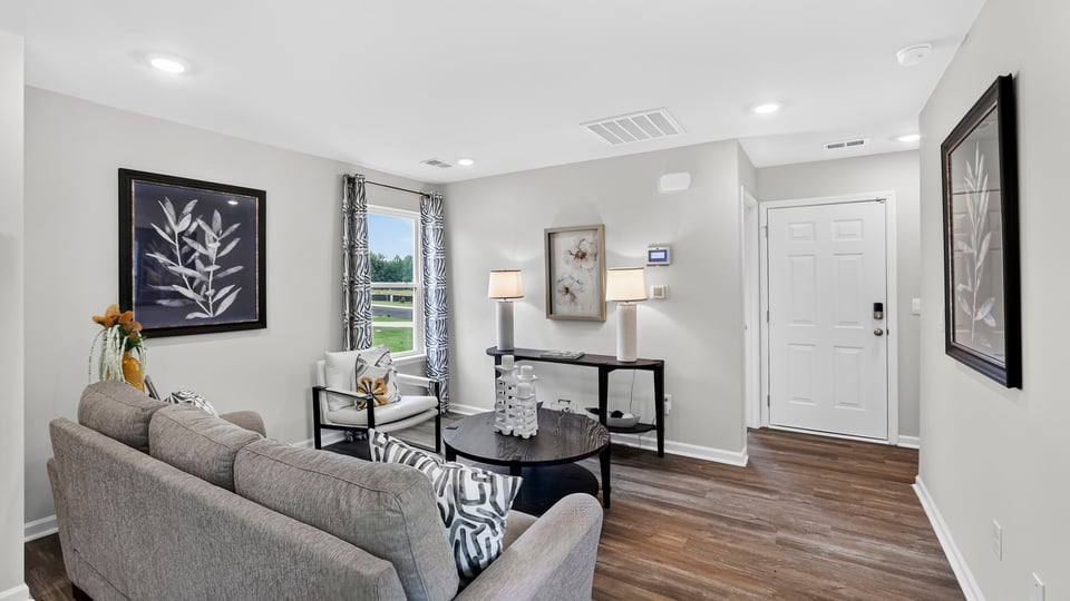 Livingroom of home with view of kitchen.