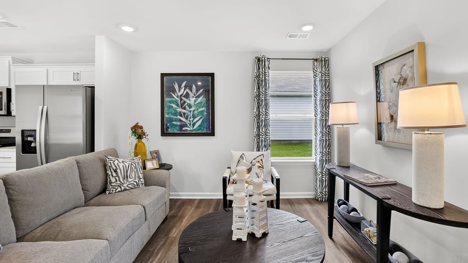 Livingroom of home with view of kitchen.