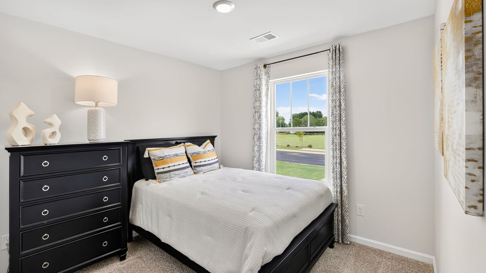 Bedroom with carpet and window.