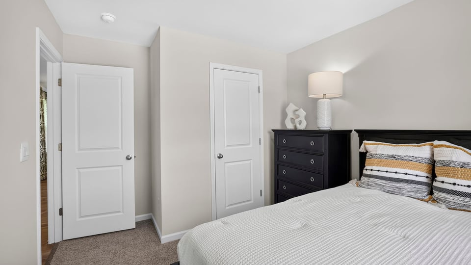 Bedroom with carpet and window.