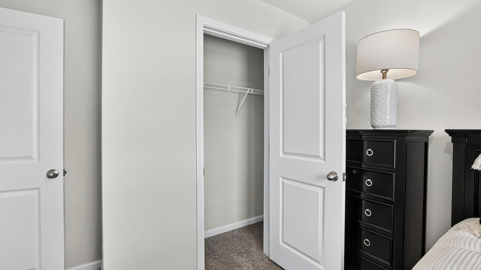 Bedroom with carpet and window.