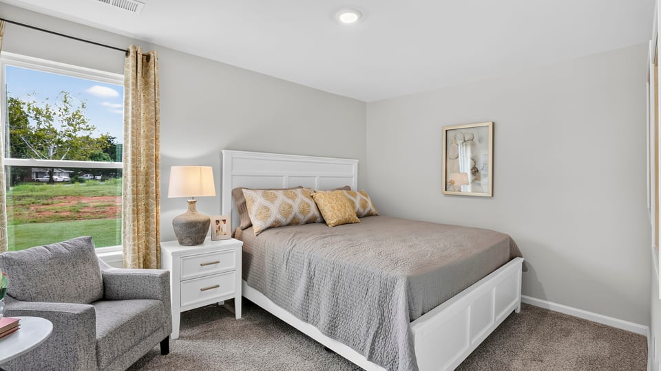 Bedroom with carpet and window.