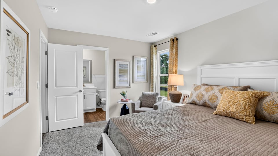Bedroom with carpet and window.