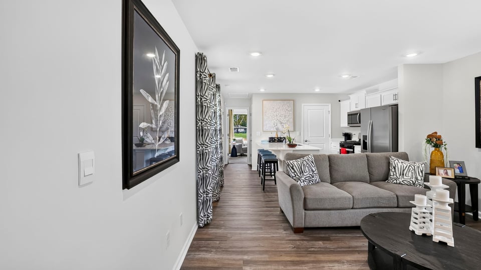 Livingroom of home with view of kitchen.