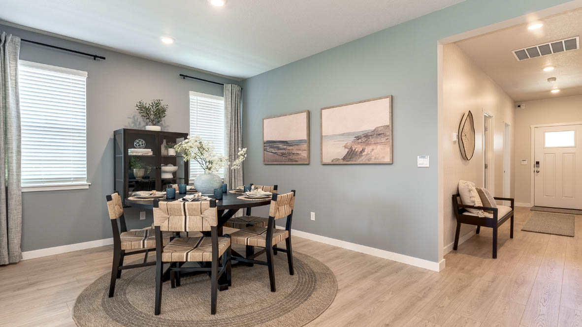 Landau Heights Dining Room with round table and four place settings with painted accent wall