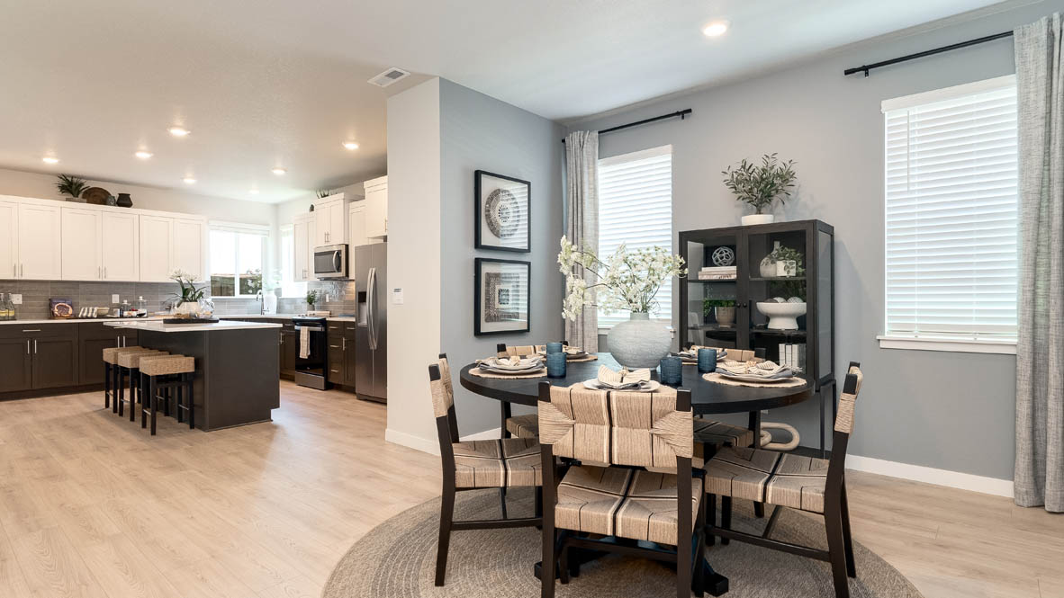 Landau Heights Dining Room with round table and four place settings with painted accent wall