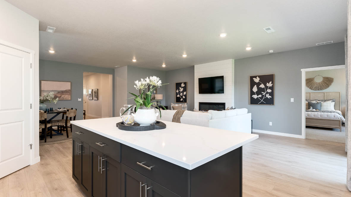 Landau Heights Kitchen with white solid surface countertops and stained shaker style cabinets and stainless steel appliances