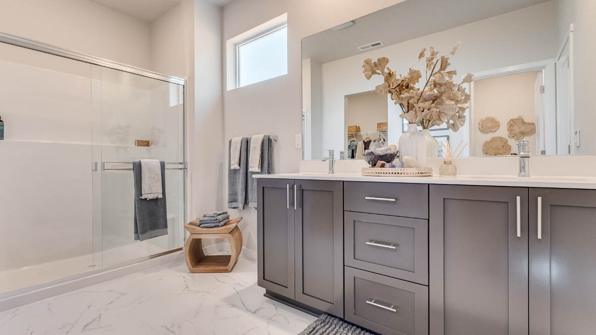 Landau Heights Primary Bathroom with double sink vanity and white quartz countertops and walk in shower