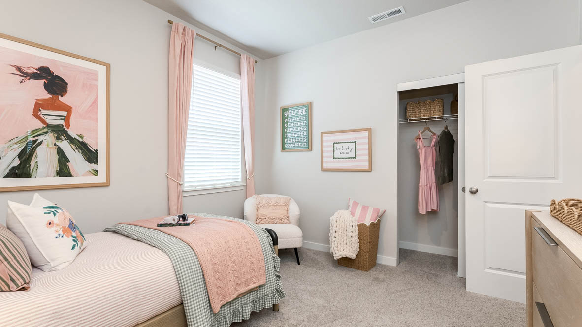Landau Heights bedroom with wall paper accent wall and pink bedroom accents