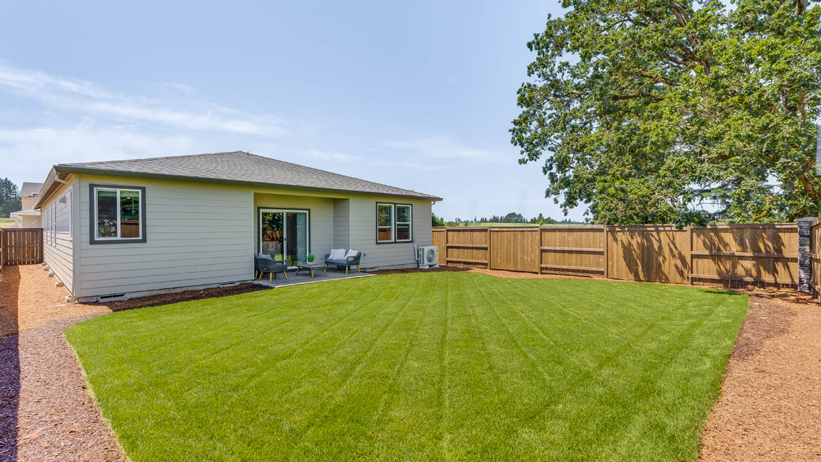 Landau Heights Backyard with grass and paved area with outdoor furniture