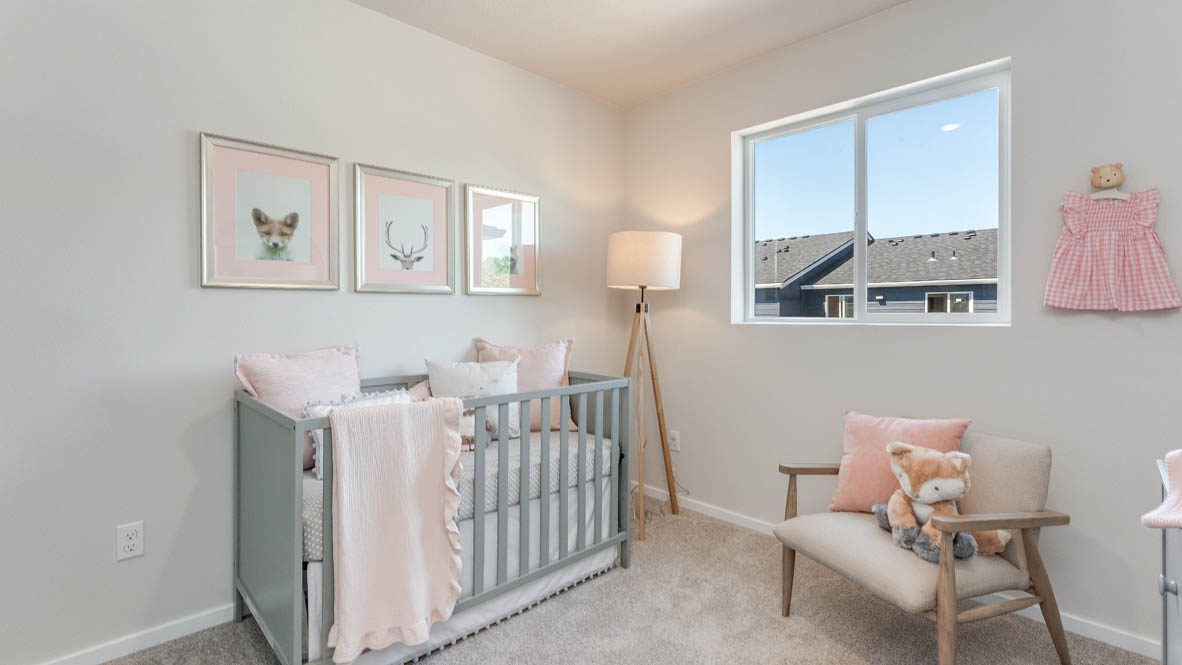 Terrace at Pleasant Valley bedroom with a baby crib, chair, two decorations, carpet, and windows