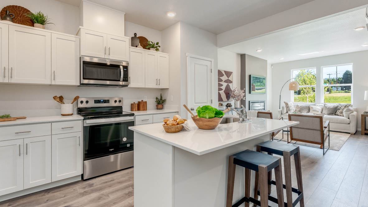 Terrace at Pleasant Valley Kitchen with an island, shaker style cabinets, solid surface countertops, and stainless steel appliances