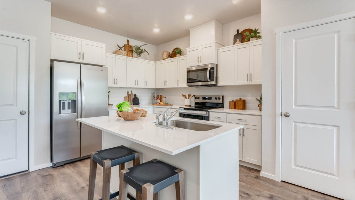 Terrace at Pleasant Valley Kitchen with an island, shaker style cabinets, solid surface countertops, stainless steel appliances