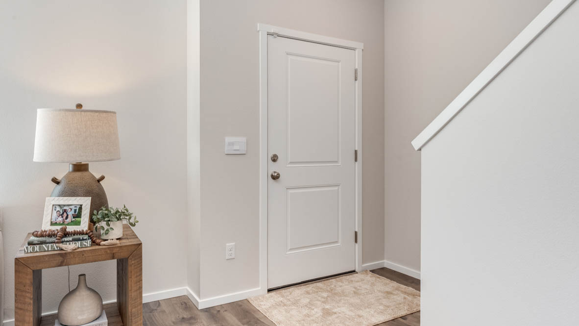 Terrace at Pleasant Valley Entry with entry rug, a side table with lamp, and staircase