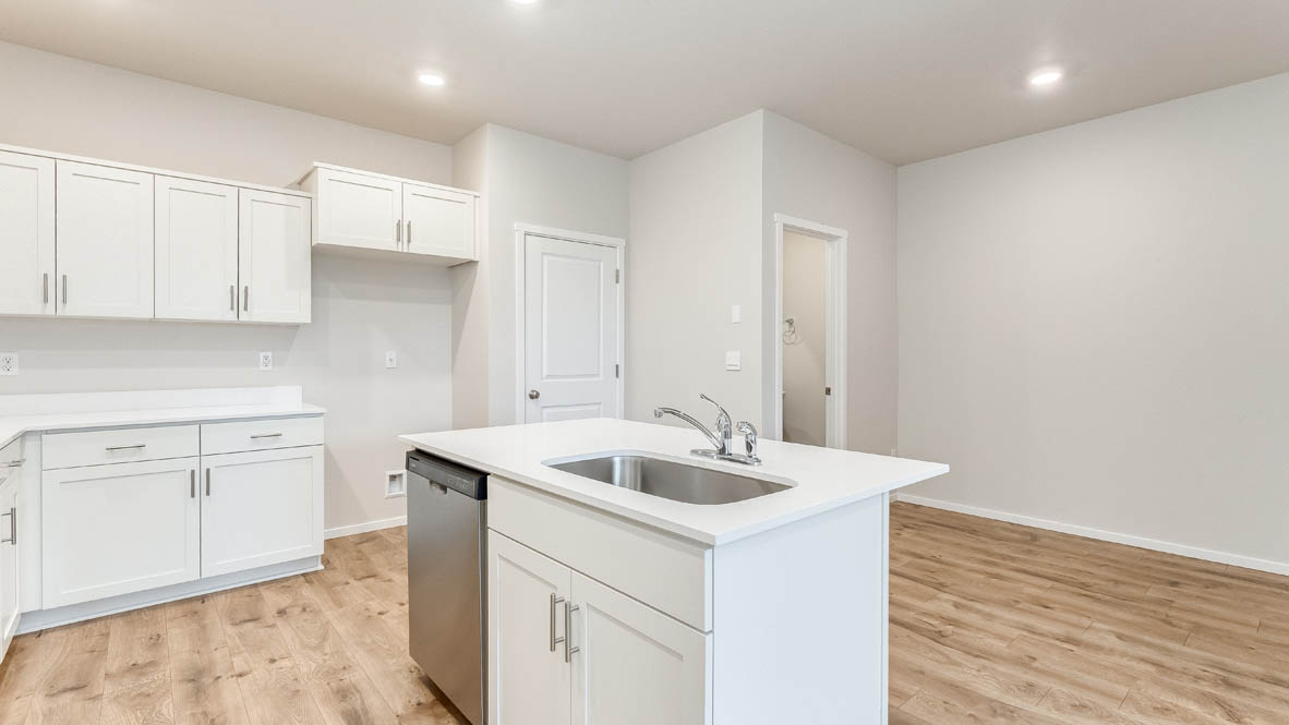 Terrace at Pleasant Valley Kitchen with laminate flooring, fireplace, island, stainless appliances, cabinets