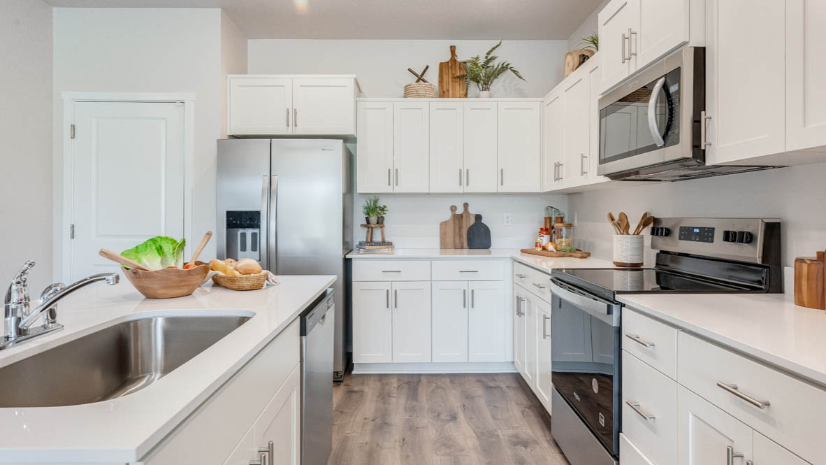 Terrace at Pleasant Valley Kitchen with an island, shaker style cabinets, solid surface countertops, and stainless steel appliances