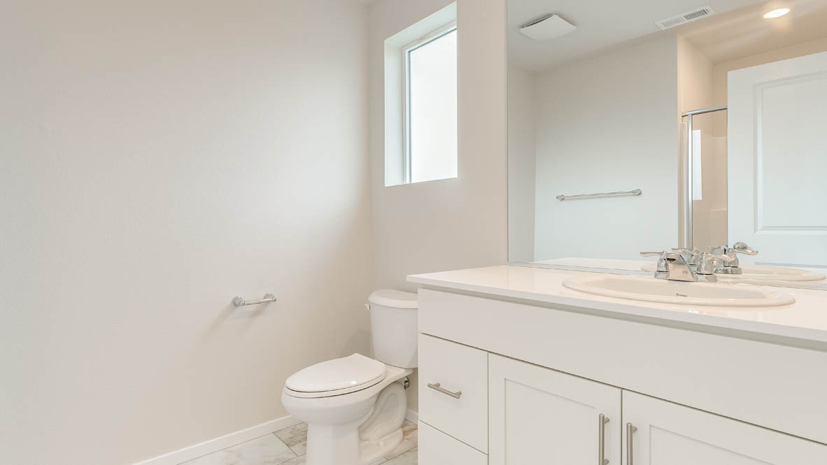 Terrace at Pleasant Valley Primary bathroom with vanity, mirror, toilet, and window