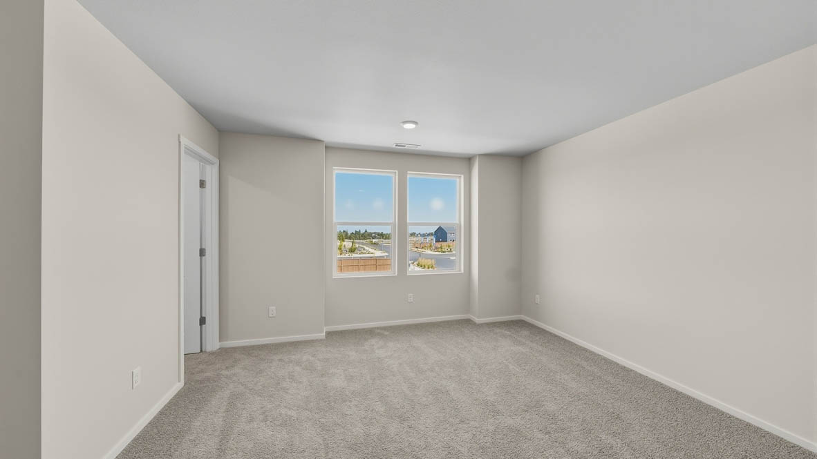 Primary bedroom with wall-to-wall carpet, a walk-in closet and an attached bathroom